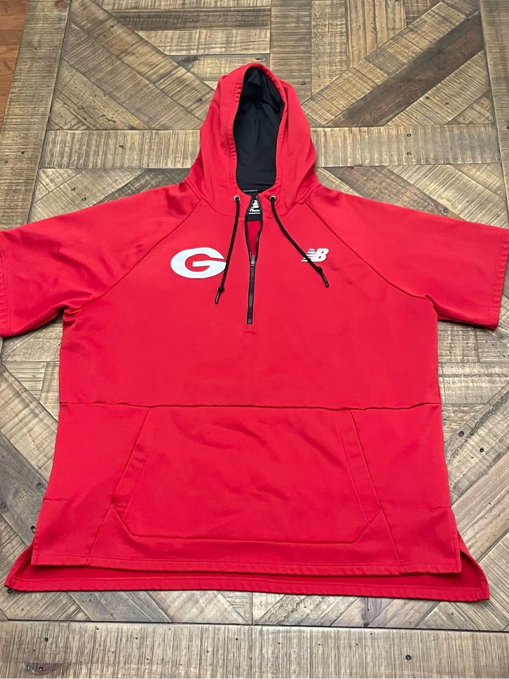 red New Balance short-sleeve hoodie featuring a Georgia Bulldogs logo
